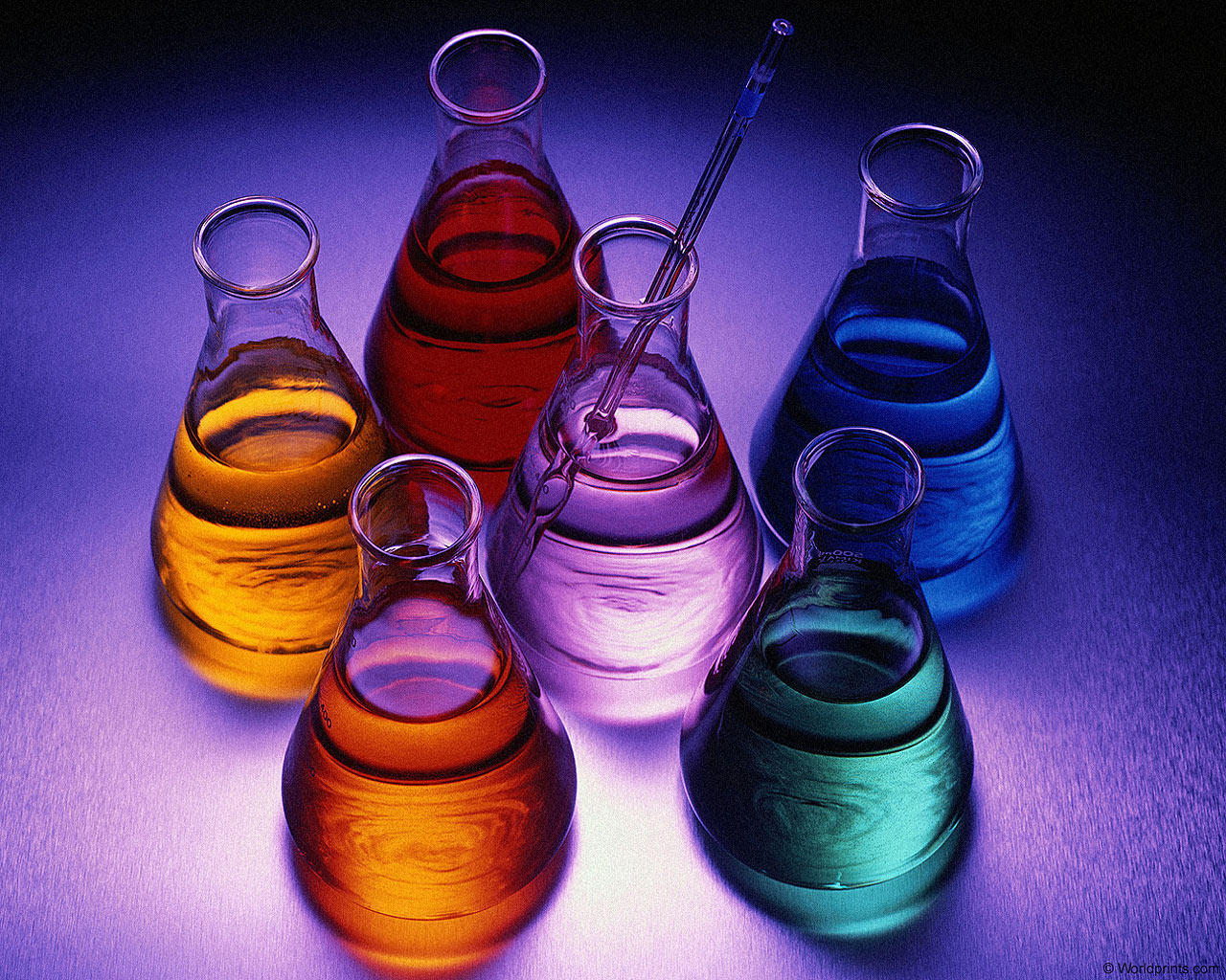 5 beakers with different colored fluids surrounding a beaker containing a clear fluid and a glass thermometer